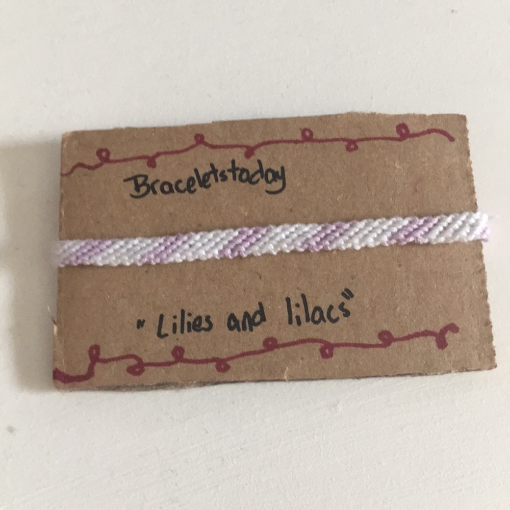 A striped styled bracelet made of cotton thread.